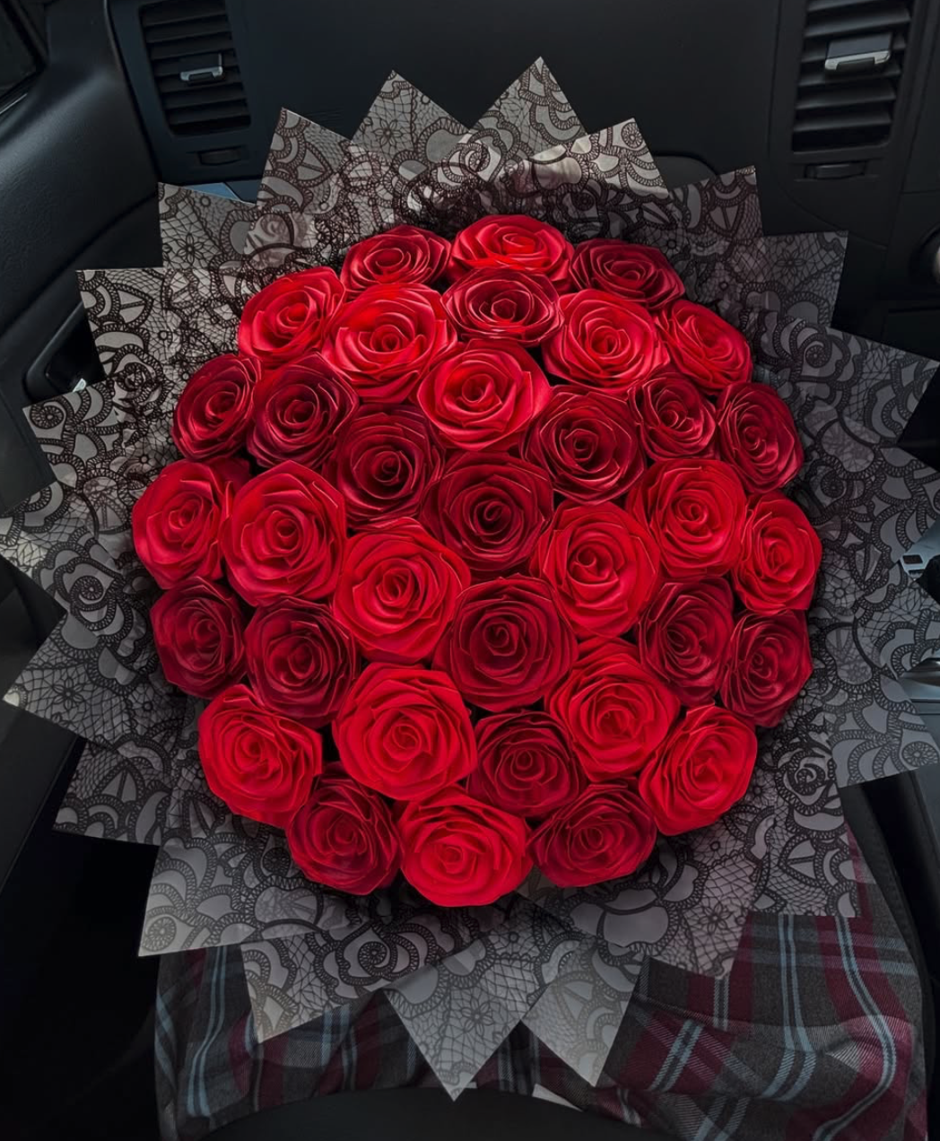 Blush handmade ribbon roses in a velvet box on marble